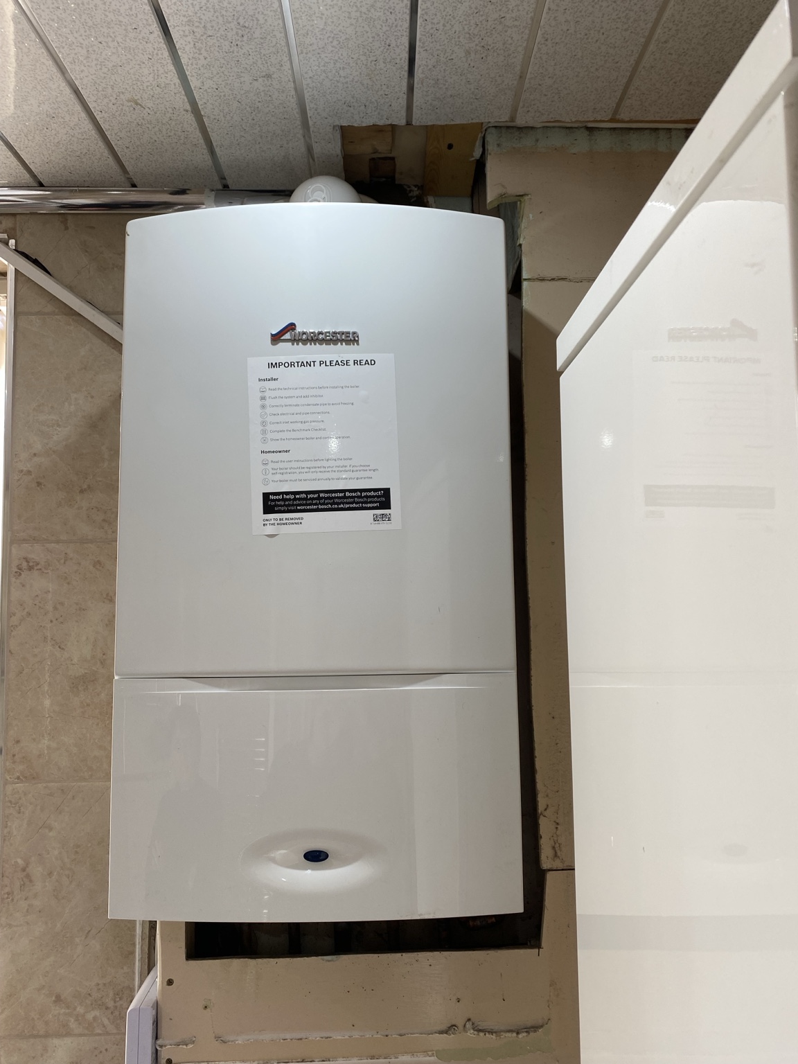 New Worcester Bosch boiler installation beside kitchen cabinetry